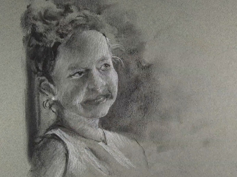 Adding white charcoal to the portrait