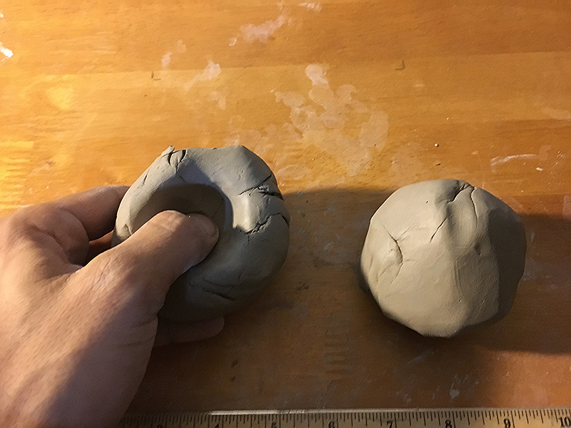 Molding clay balls into half spheres