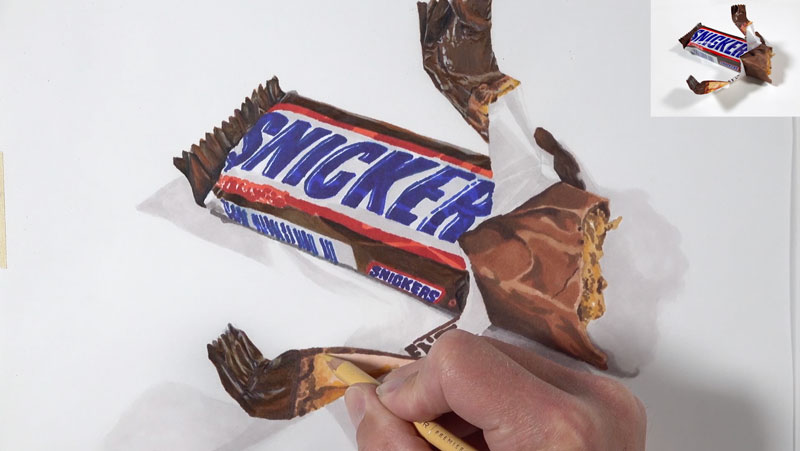 Layering colored pencils on the wrapper of the candy bar