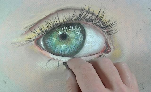 A black pastel pencil is used to paint the eyelashes